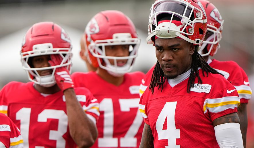Kansas City Chiefs wide receiver Rashee Rice (4) waits with teammates to start a drill during NFL football training camp Friday, July 31, 2026, in St. Joseph, Mo. (AP Photo/Charlie Riedel)