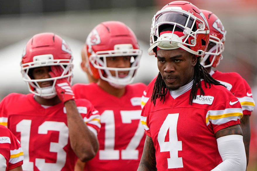 Kansas City Chiefs wide receiver Rashee Rice (4) waits with teammates to start a drill during NFL football training camp Friday, July 31, 2026, in St. Joseph, Mo. (AP Photo/Charlie Riedel)