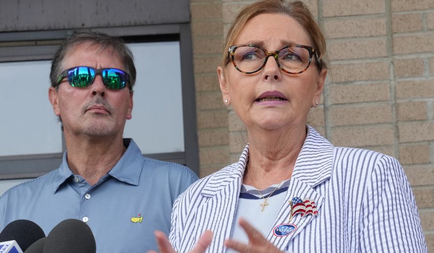 Larry Nordone looks on as his wife, U.S. Sen. Darline Graham, R-S.C., speaks to reporters after she voted in a special Republican primary to replace her brother, U.S. Sen. Lindsey Graham, R-S.C., on November ballots on Tuesday, Aug. 11, 2026, in Florence, S.C. (AP Photo/Meg Kinnard)