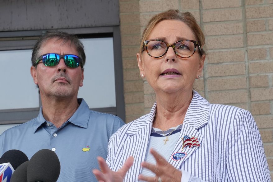 Larry Nordone looks on as his wife, U.S. Sen. Darline Graham, R-S.C., speaks to reporters after she voted in a special Republican primary to replace her brother, U.S. Sen. Lindsey Graham, R-S.C., on November ballots on Tuesday, Aug. 11, 2026, in Florence, S.C. (AP Photo/Meg Kinnard)