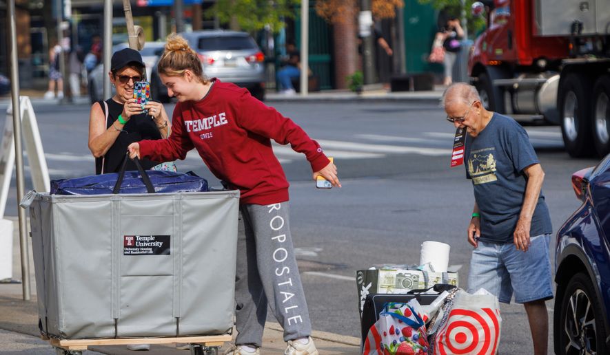 FILE - Emily Danenhower, 17, loads her container as grandparents Rena Ruben and Walter McClain help move her into college as students moved into their dorms during move-in-day at Temple University in Philadelphia, on Monday, Aug. 21, 2023. (Alejandro A. Alvarez/The Philadelphia Inquirer via AP, File)