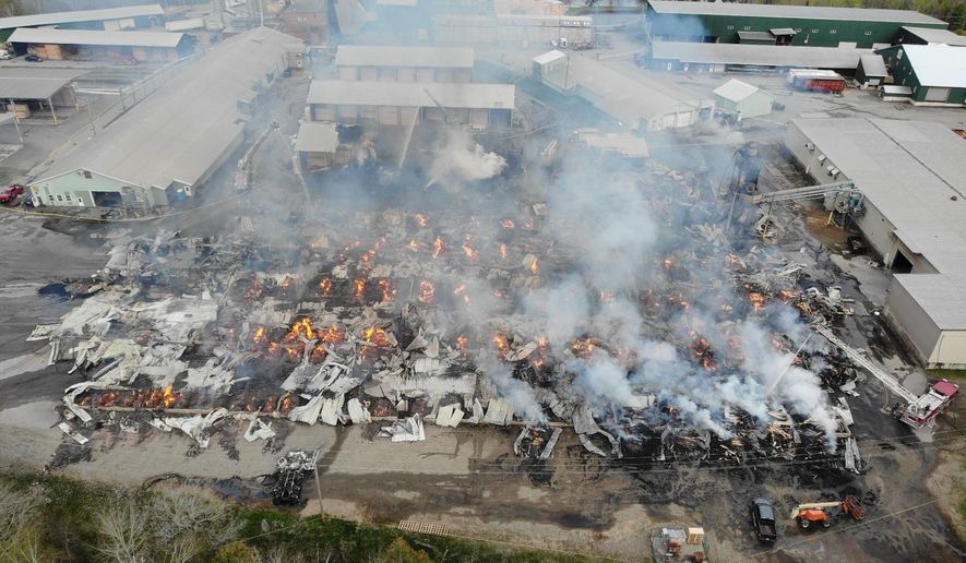 In this photo provided by the Maine State Fire Marshal, flames burn through Robbins Lumber following an explosion, May 15, 2026, in Searsmont, Maine. (Maine State Fire Marshal via AP)