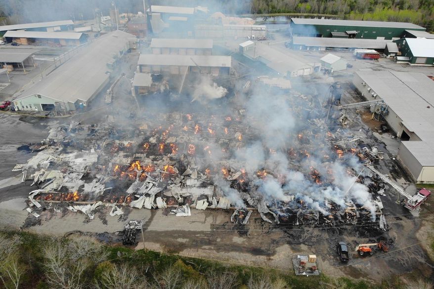 In this photo provided by the Maine State Fire Marshal, flames burn through Robbins Lumber following an explosion, May 15, 2026, in Searsmont, Maine. (Maine State Fire Marshal via AP)