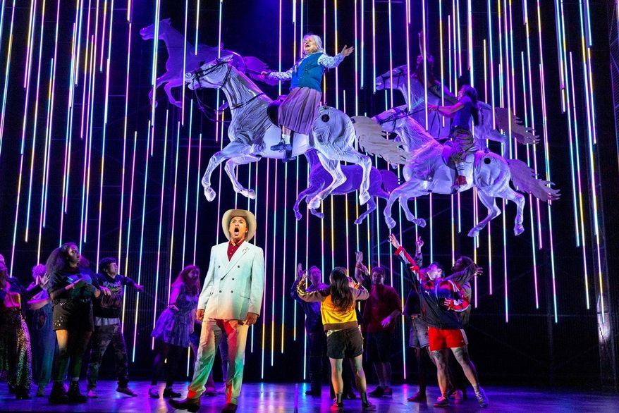 This image released by the Scottish Opera shows Justin Austin, foreground center, and Susan Bullock, top center, during a performance of "The Galloping Cure," at Theatre Royal Glasgow on July 28, 2026 in Glasgow, Scotland. (Antonia Bain/Scottish Opera via AP)