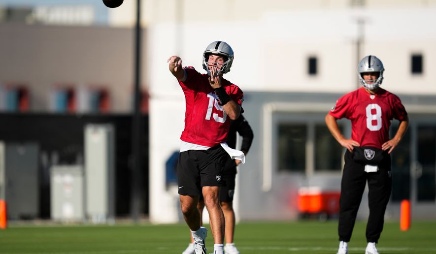 Las Vegas Raiders quarterback Fernando Mendoza (15) throws during practice at the team's NFL football training camp, Wednesday, July 29, 2026, in Henderson, Nev. (AP Photo/Lucas Peltier)