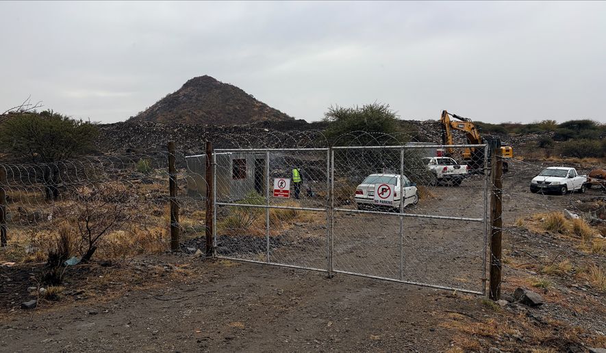 A gate is shown at a mining site where at least 14 artisanal miners died near Rustenburg, South Africa, Tuesday, Aug. 11, 2026. (AP Photo/Nqobile Ntshangase)