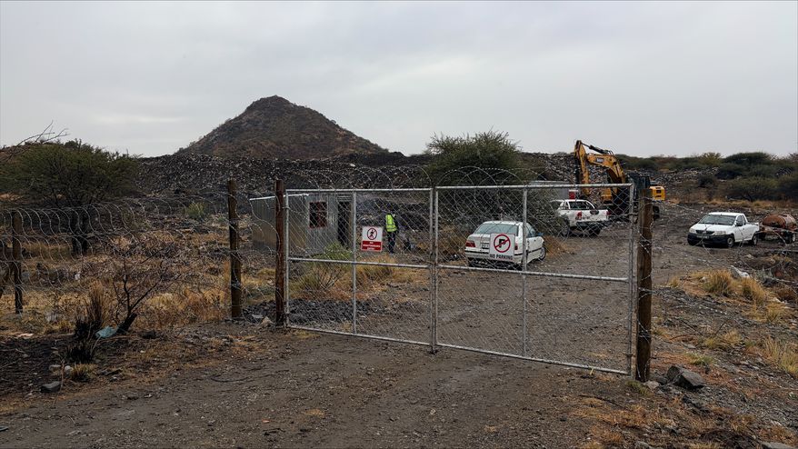 A gate is shown at a mining site where at least 14 artisanal miners died near Rustenburg, South Africa, Tuesday, Aug. 11, 2026. (AP Photo/Nqobile Ntshangase)