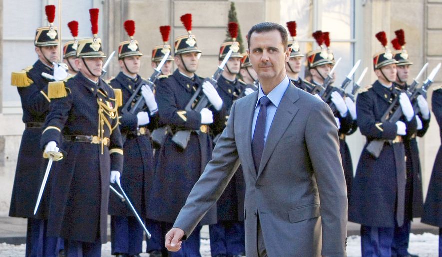 In this Dec. 9, 2010, file photo, Syrian President Bashar Assad arrives at the Elysee Palace in Paris for his meeting with French President Nicolas Sarkozy. (AP Photo/Remy de la Mauviniere, File)