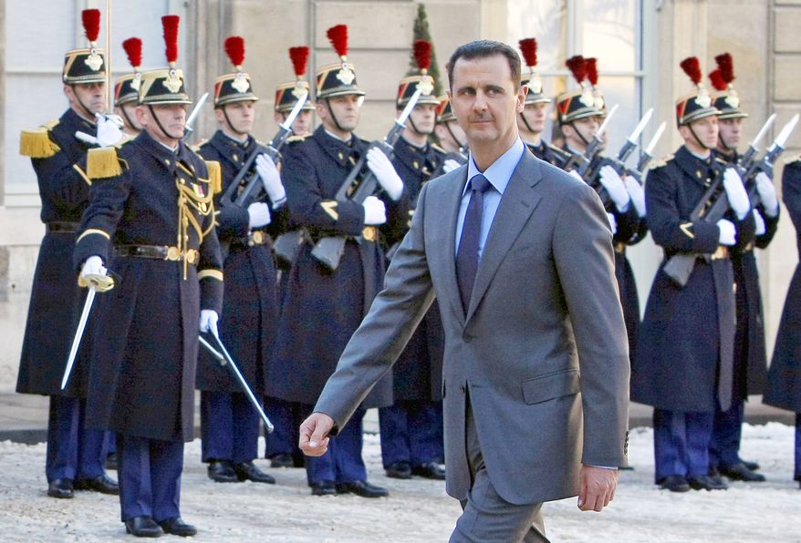In this Dec. 9, 2010, file photo, Syrian President Bashar Assad arrives at the Elysee Palace in Paris for his meeting with French President Nicolas Sarkozy. (AP Photo/Remy de la Mauviniere, File)