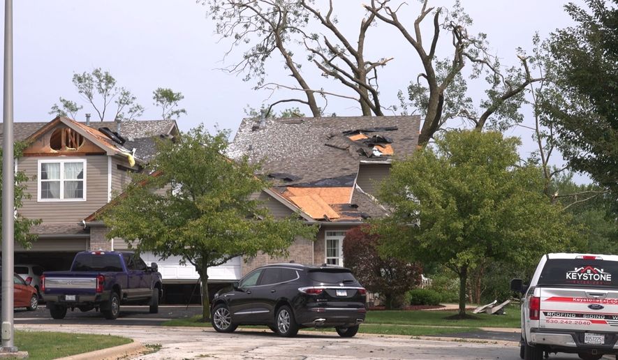 In this image made from video, a roof is damaged after a strong storm in Tinley Park, Ill., Tuesday, Aug. 11, 2026. (AP Photo/Laura Bargfeld)