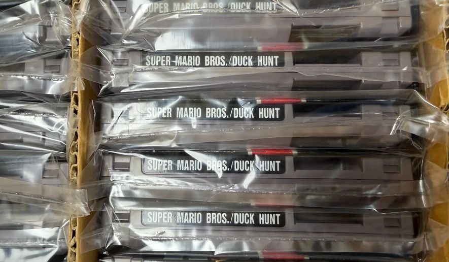 This photo provided by Nintendo Wire shows a box of nearly 100 uncirculated Nintendo Entertainment System copies of Super Mario Bros. and Duck Hunt on Wednesday, June 17, 2026, rediscovered in a warehouse in Waukesha, Wis., by OneStopWonders store owner Kevin Braun and Nintendo Wire publisher Jason Ganos. (Jason Ganos/Nintendo Wire via AP)