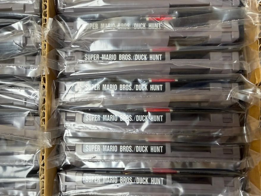 This photo provided by Nintendo Wire shows a box of nearly 100 uncirculated Nintendo Entertainment System copies of Super Mario Bros. and Duck Hunt on Wednesday, June 17, 2026, rediscovered in a warehouse in Waukesha, Wis., by OneStopWonders store owner Kevin Braun and Nintendo Wire publisher Jason Ganos. (Jason Ganos/Nintendo Wire via AP)