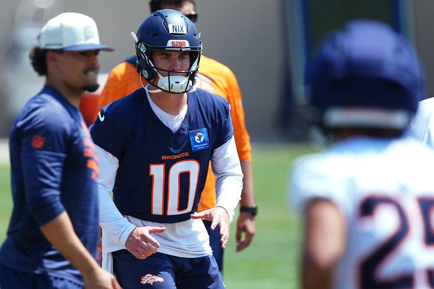 Denver Broncos quarterback Bo Nix takes part in drills at the team's NFL football training camp Wednesday, Aug. 12, 2026, in Centennial, Colo. (AP Photo/David Zalubowski)