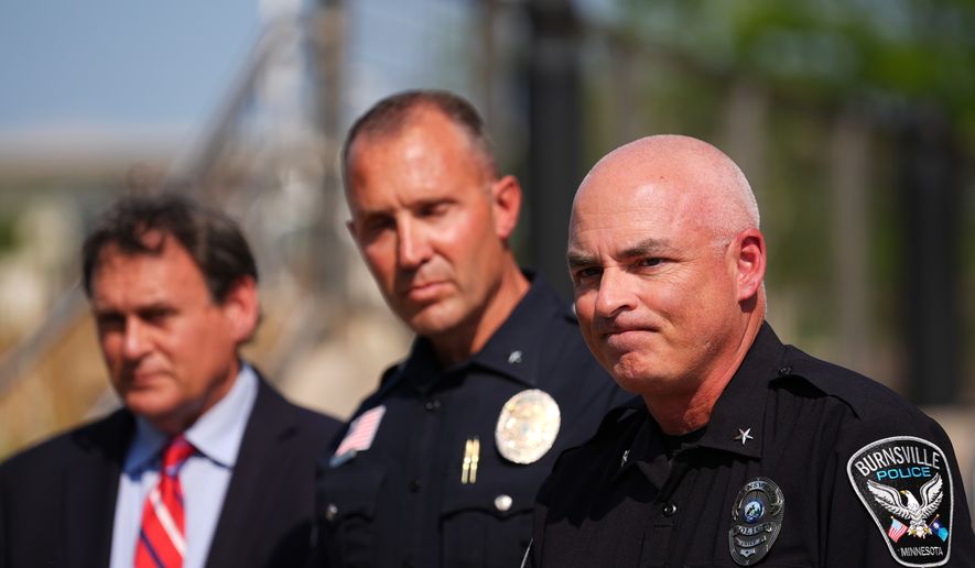 Burnsville Police Chief Matt Smith, right, attends a news conference in Hopkins, Minn., Wednesday, Aug. 12, 2026, where police said a man who killed his wife and their 7-year-old daughter at an in-home daycare is also suspected of killing a 78-year-old female relative. (AP Photo/Ellen Schmidt)