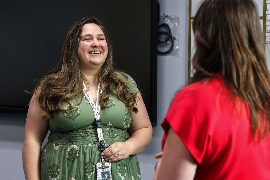 Elementary school teacher Emily Henderson speaks with the high school guidance counselor about back-to-school planning ahead of the school year at BASIS Flagstaff on Thursday, Aug. 6, 2026, in Flagstaff, Ariz. (AP Photo/Cheyanne Mumphrey)