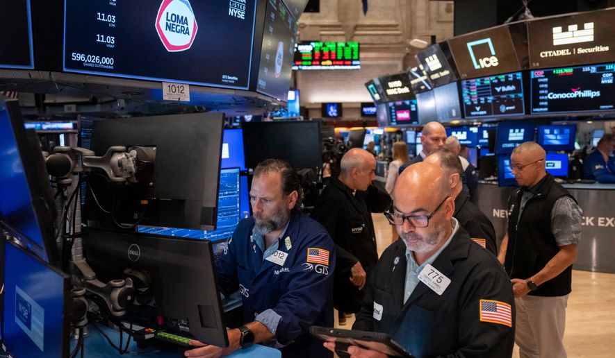 Trader Fred Demarco, right, and Specialist Michael Pistillo, left, work on the floor of the New York Stock Exchange, Friday, Aug. 7, 2026, in New York. (AP Photo/Yuki Iwamura)