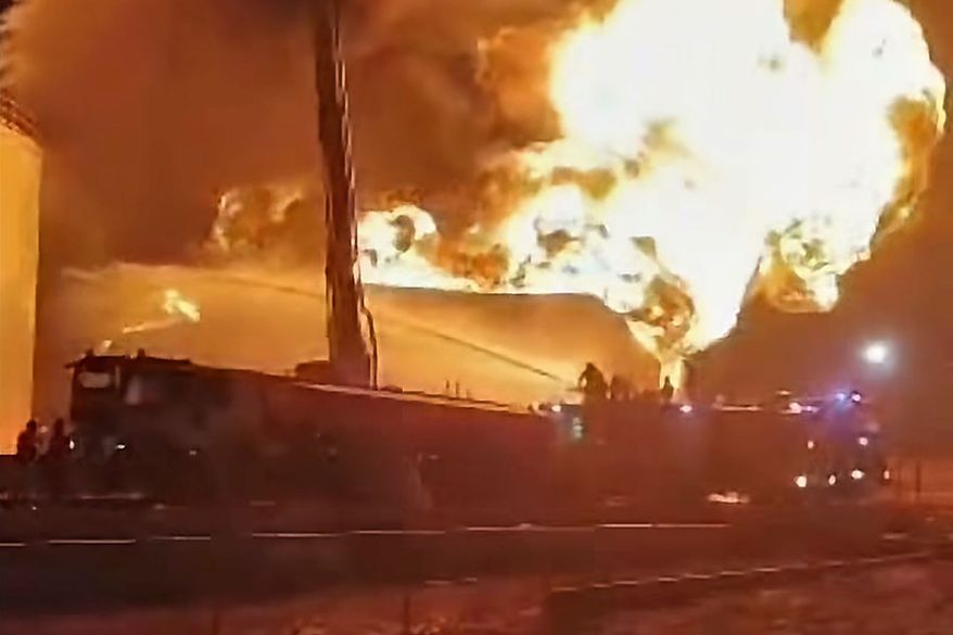 This frame grab from a video shows firefighters working to contain a fire at the Zawiya oil refinery following a drone strike in Zawiya, Libya, Tuesday, Aug. 11, 2026. (Libyan Fire Department via AP) ** FILE **