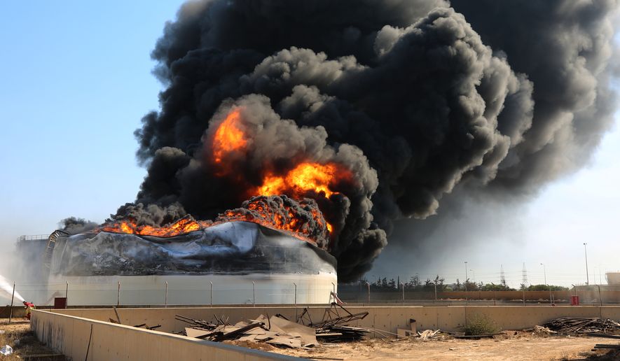 Flames and thick black smoke rise from a fuel storage tank at the Zawiya oil refinery following a drone strike in Zawiya, Libya, Tuesday, Aug. 11, 2026. (AP Photo/Yousef Murad) ** FILE **