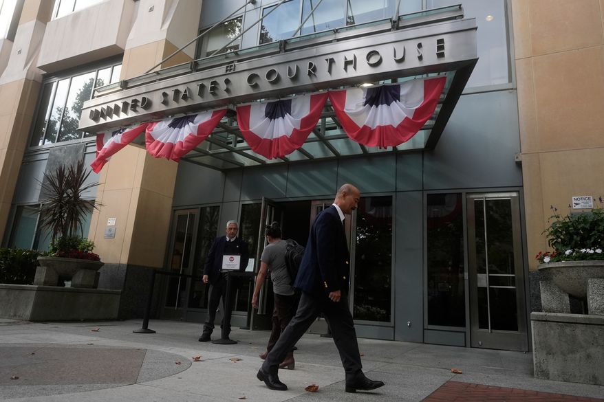 People walk outside of a Federal Courthouse Wednesday, Aug. 12, 2026, in Oakland, Calif. (AP Photo/Jeff Chiu)