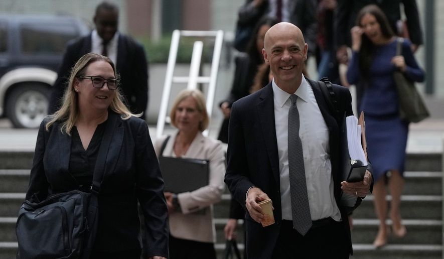 Attorney Paul W. Schmidt, representing Meta, right, arrives at a Federal Courthouse Wednesday, Aug. 12, 2026, in Oakland, Calif. (AP Photo/Jeff Chiu)