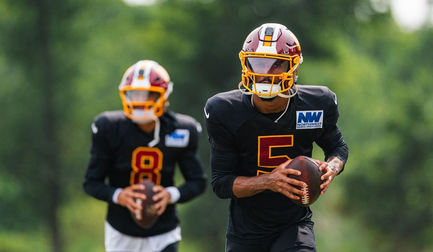 Quarterbacks Jayden Daniels (5) and Marcus Mariota (8) drill at the Washington Commanders 2026 Training Camp joint practice with the Miami Dolphins at the BigBear.ai Performance Center in Ashburn, Virginia on August 12th, 2026. (Photo by Jordan Sabillo for The Washington Times)