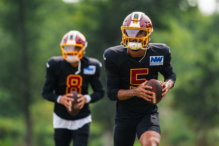 Quarterbacks Jayden Daniels (5) and Marcus Mariota (8) drill at the Washington Commanders 2026 Training Camp joint practice with the Miami Dolphins at the BigBear.ai Performance Center in Ashburn, Virginia on August 12th, 2026. (Photo by Jordan Sabillo for The Washington Times)