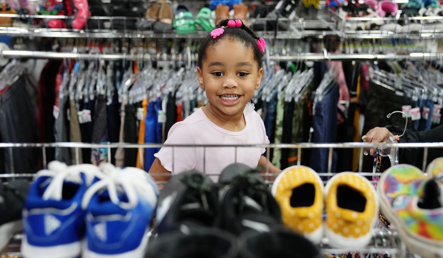 Deanna Pearson, 4, browses the children's shoe section at a Goodwill store in Roseville, Minn., Wednesday, Aug. 12, 2026. (AP Photo/Ellen Schmidt)