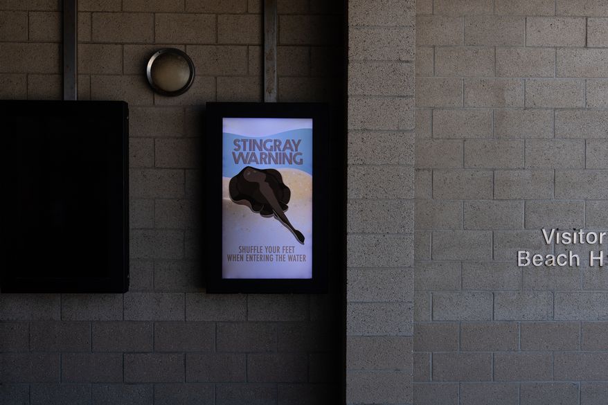 A stingray warning is displayed at Bolsa Chica State Beach in Huntington Beach, Calif., Friday, July 24, 2026. (AP Photo/Jae C. Hong)
