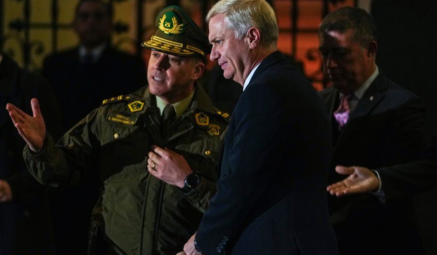Chilean President José Antonio Kast visits with police officers after announcing a new security agenda and stricter immigration enforcement, at the Plaza de Armas in Santiago, Chile, Thursday, Aug. 6, 2026. (AP Photo/Esteban Felix)