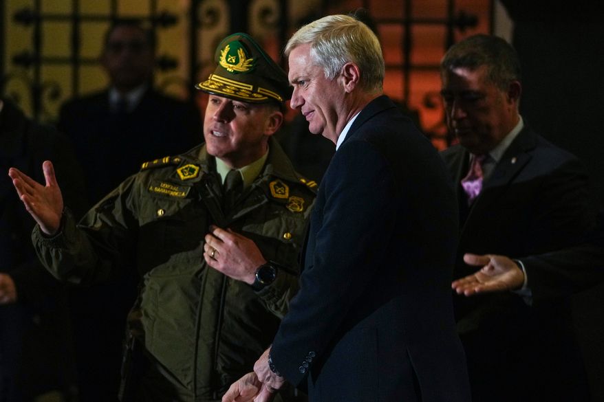 Chilean President José Antonio Kast visits with police officers after announcing a new security agenda and stricter immigration enforcement, at the Plaza de Armas in Santiago, Chile, Thursday, Aug. 6, 2026. (AP Photo/Esteban Felix)