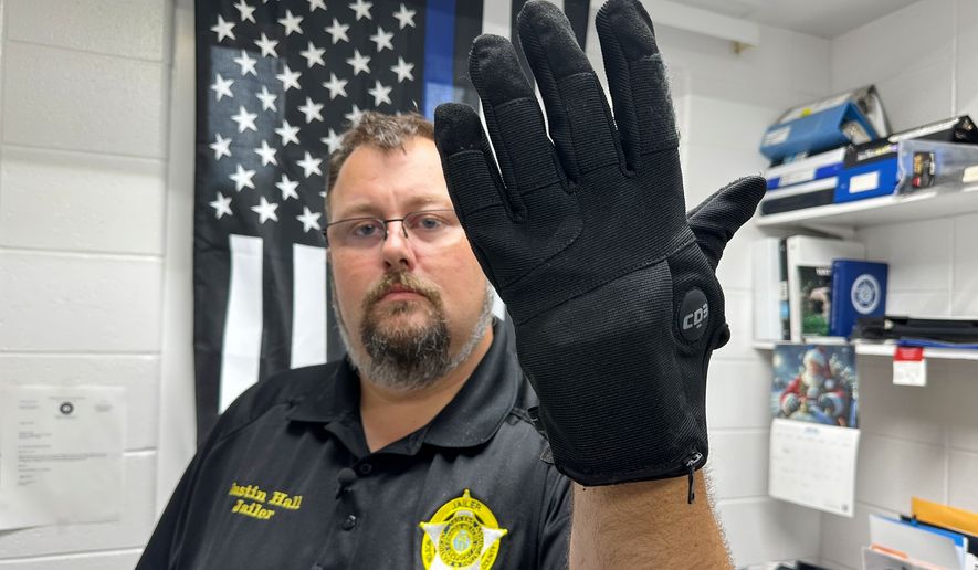 Nelson County, Ky., jailer Justin Hall shows an electric shock glove that is used at his facility, Thursday, Aug. 13, 2026, in Bardstown, Ky. (AP Photo/Dylan Lovan)