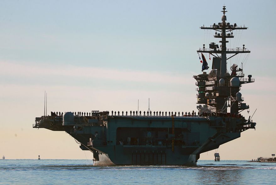 Sailors and Marines line the deck of aircraft carrier USS Abraham Lincoln (CVN-72) as it deploys from San Diego on Jan. 3, 2021. (K.C. Alfred/The San Diego Union-Tribune via AP) **FILE**
