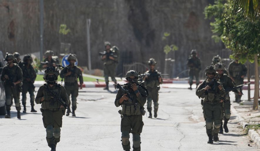Israeli army soldiers patrol the streets of the occupied West Bank village of Qusra, south of Nablus, Thursday, Aug. 13, 2026. (AP Photo/Majdi Mohammed) ** FILE **