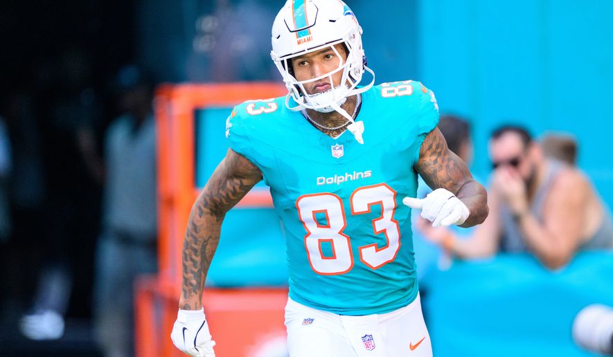 FILE - Miami Dolphins tight end Darren Waller (83) runs onto the field during player introductions before an NFL football game against the Tampa Bay Buccaneers, on Dec. 28, 2025, in Miami Gardens, Fla. (AP Photo/Doug Murray, File)
