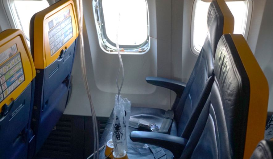 This undated photo provided by the National Transportation Safety Board on Thursday, Aug. 13, 2026, shows the shattered window on a Ryanair plane that was broken by a stray engine part shortly after takeoff, causing a man's head to be sucked into the hole. (National Transportation Safety Board via AP)