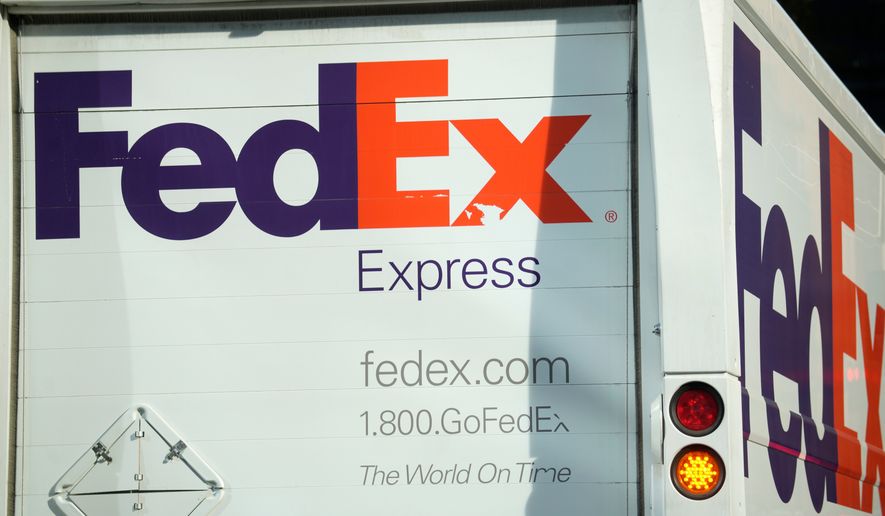 FILE - The company logo is shown on a FedEx delivery van, Sept. 13, 2023, in downtown Denver. (AP Photo/David Zalubowski, File)