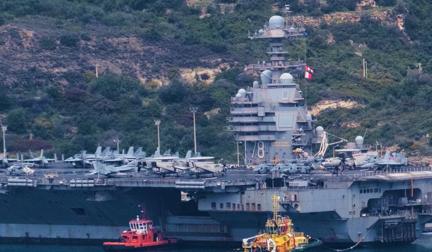 The USS Gerald R. Ford aircraft carrier is docked at Souda Naval Base near Chania on the island of Crete, Monday, March 23, 2026. (AP Photo/Giannis Angelakis).