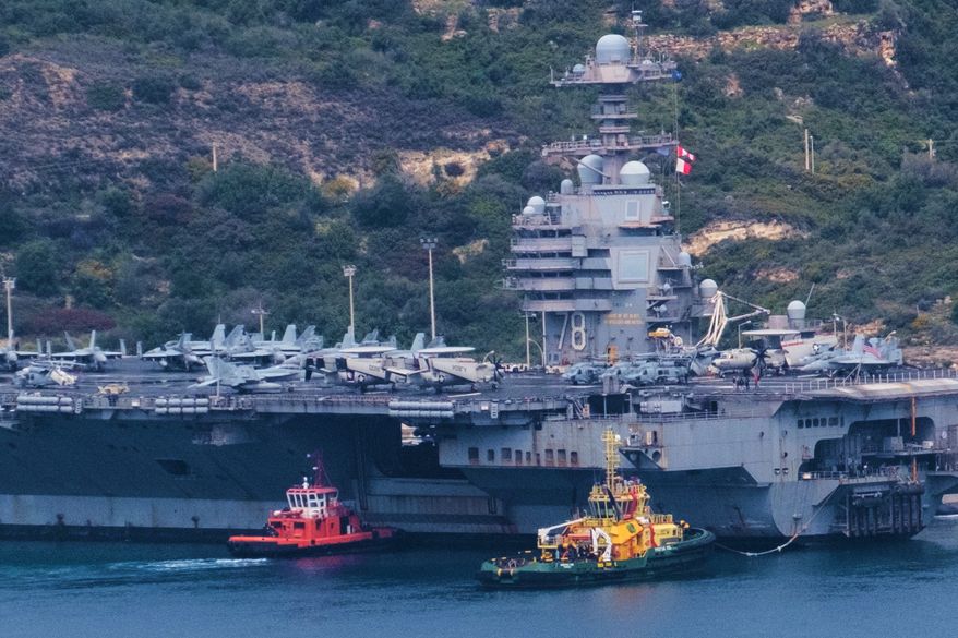 The USS Gerald R. Ford aircraft carrier is docked at Souda Naval Base near Chania on the island of Crete, Monday, March 23, 2026. (AP Photo/Giannis Angelakis).