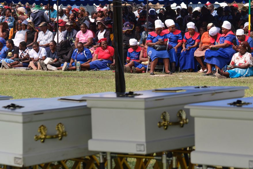Mourners gather for a memorial service for the victims of a ferry capsized on lake Kariba in Kariba, Zimbabwe, Thursday, Aug. 13, 2026. (AP Photo/Mkhululi Thobela)