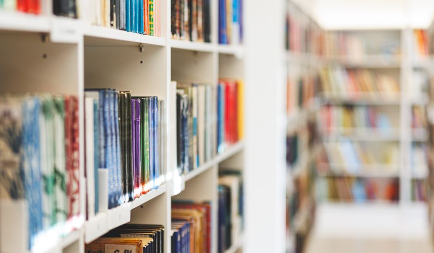 Books on the bookshelf in public library. File photo credit: Rokas Tenys via Shutterstock.
