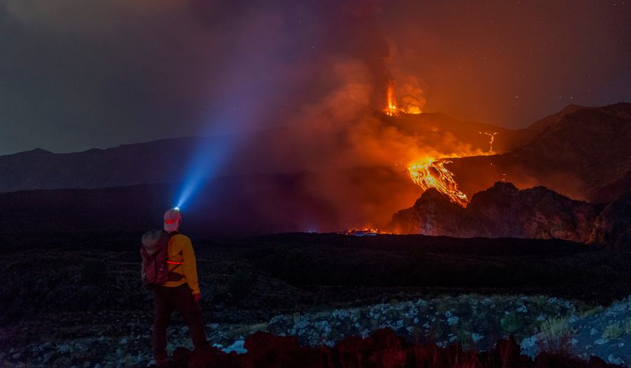 Eruptive activity continues on Mount Etna, where lava flows continue to descend on the slopes of the volcano, as seen from Mareneve near Catania, Italy, Thursday, Aug. 13, 2026. (AP Photo/Salvatore Allegra)