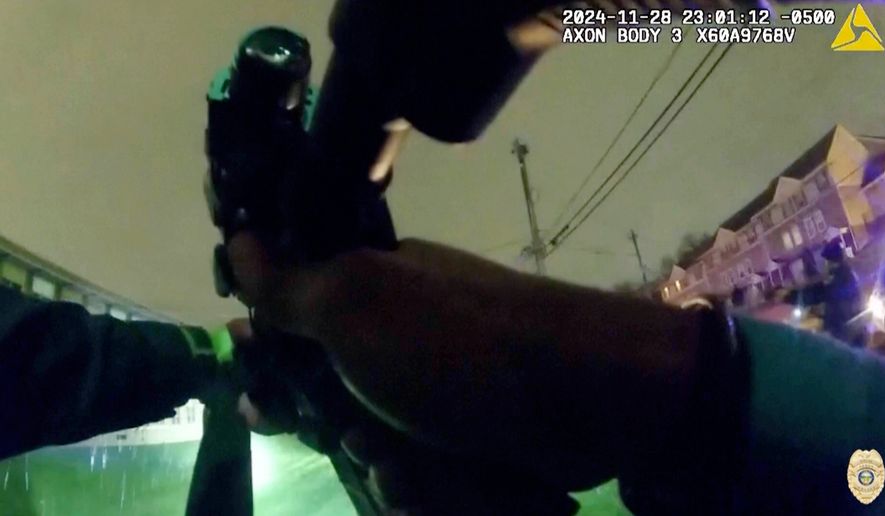 In this image from police body camera video provided by the Akron, Ohio Police Department, officers display their weapons as they confront 15-year-old boy Jazmir Tucker in Akron, Ohio, late Nov. 28, 2024. (Akron Police Department via AP)