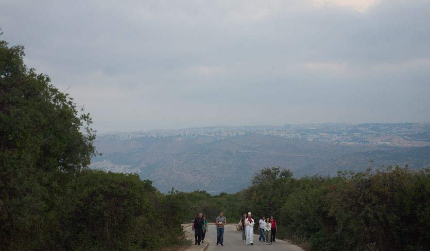 Rev. Fadi Shallufi leads Catholic pilgrims on a Eucharistic procession climbing to the Basilica of the Transfiguration on Mount Tabor, northern Israel, on Aug. 6, 2026. (AP Photo/Ariel Schalit)