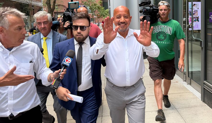 Lawrence, Mass., Mayor Brian DePena waves as he leaves federal court in Boston on Friday, Aug. 14, 2026, after making an initial appearance on charges that he fraudulently obtained a pandemic loan and using the money to fund election campaign, pay off high-interest mortgages and back taxes. (AP Photos/Michael Casey)