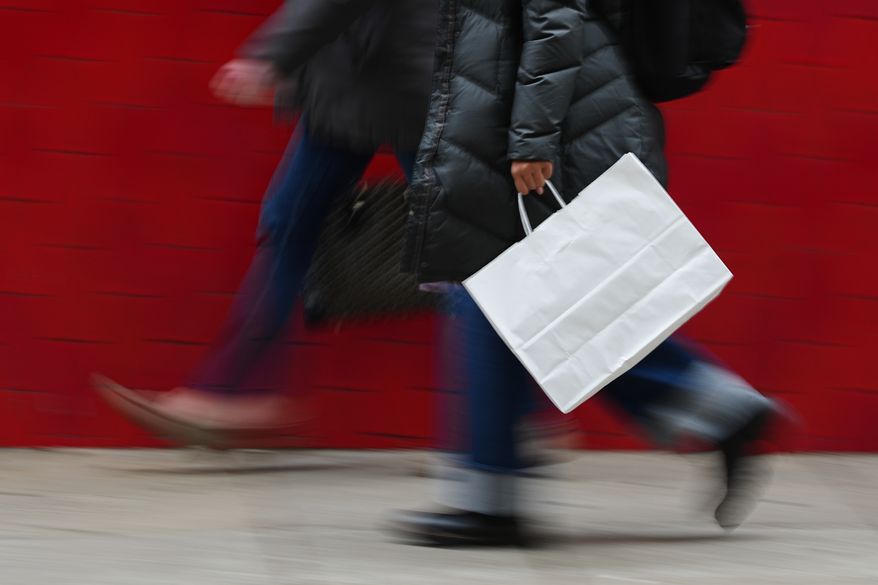 A person carries a shopping bag in Philadelphia on Dec. 10, 2025. (AP Photo/Matt Rourke) **FILE**