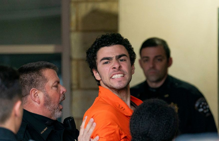 FILE - Suspect Luigi Mangione is taken into the Blair County Courthouse on Tuesday, Dec. 10, 2024, in Hollidaysburg, Pa. (Benjamin B. Braun/Pittsburgh Post-Gazette via AP, File)