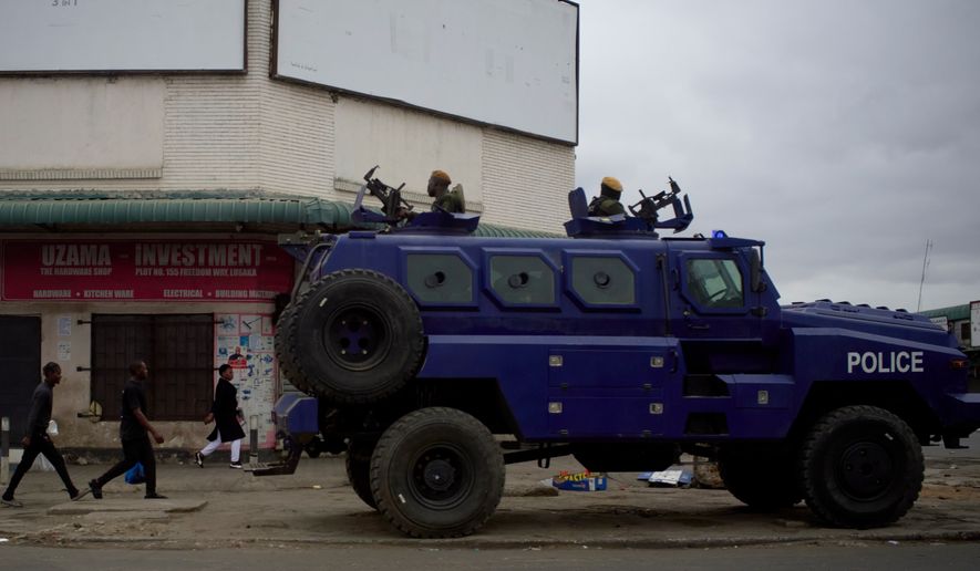 A police vehicle is parked on a sidewalk, on the outskirts of Lusaka, Zambia, Friday, Aug. 14, 2026. (AP Photo/Alfonso Nqunjana)