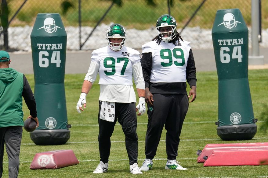 New York Jets' Harrison Phillips (97) and T'Vondre Sweat (99) participate in an NFL football practice in Florham Park, N.J., June 10, 2026. (AP Photo/Seth Wenig, File)
