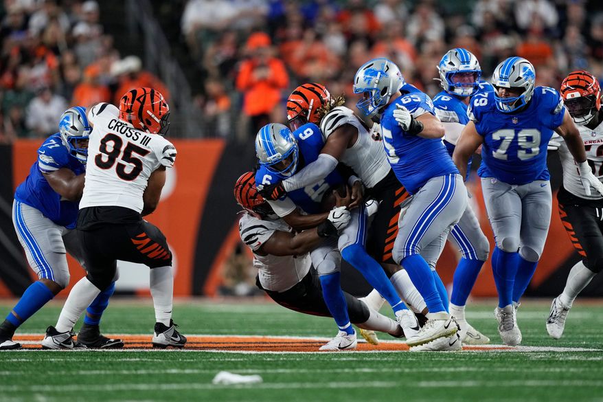 Detroit Lions quarterback Josh Dobbs (6) is sacked by the Cincinnati Bengals defensive tackle Kris Jenkins Jr. (90) during the first half of a preseason NFL football game Thursday, Aug. 13, 2026, in Cincinnati. (AP Photo/Carolyn Kaster)