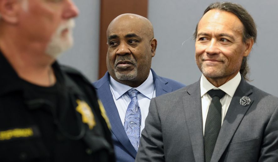 Duane Davis, center, stands with his attorney Michael Sanft, right, as prospective jurors enter the courtroom during the fourth day of jury selection for his murder trial in Clark County District Court at the Regional Justice Center on Thursday, Aug. 13, 2026, in Las Vegas. Davis was indicted on murder charges for his involvement in the killing of rapper Tupac Shakur in 1996. (Bizuayehu Tesfaye/Las Vegas Review-Journal via AP, Pool)